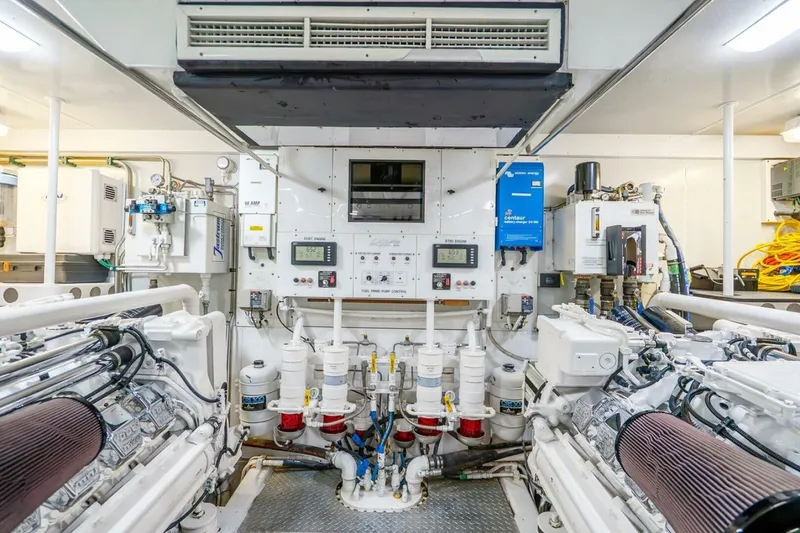 Slide: The Image of Engine room of a 2008 Lazzara Motor Yacht, showcasing machinery and control panels. - 76