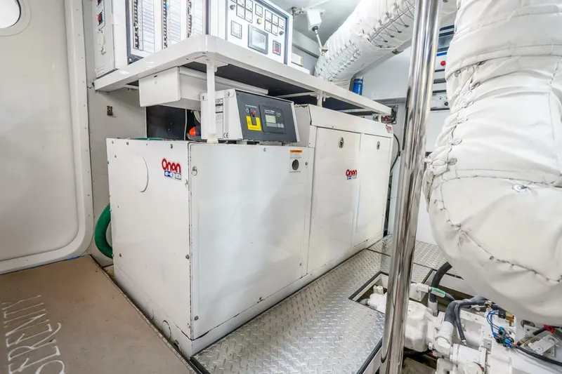 Slide: The Image of Engine room of 2008 Lazzara Motor Yacht featuring Onan generator and control panels. - 81