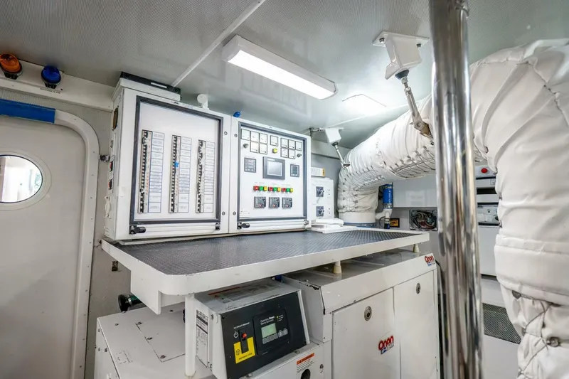 Slide: The Image of Engine room of a 2008 Lazzara Motor Yacht with control panels and equipment. - 82