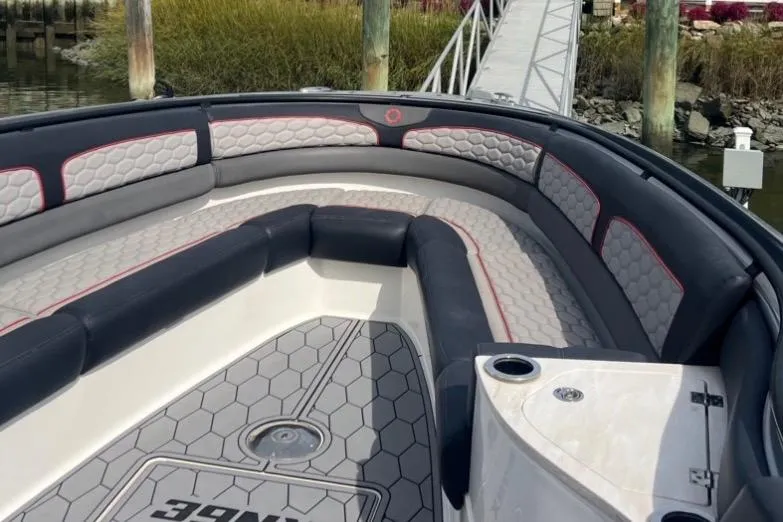 Slide: The Image of 2021 Fountain 39 NX boat interior with cushioned seating and hexagonal floor design. - 10
