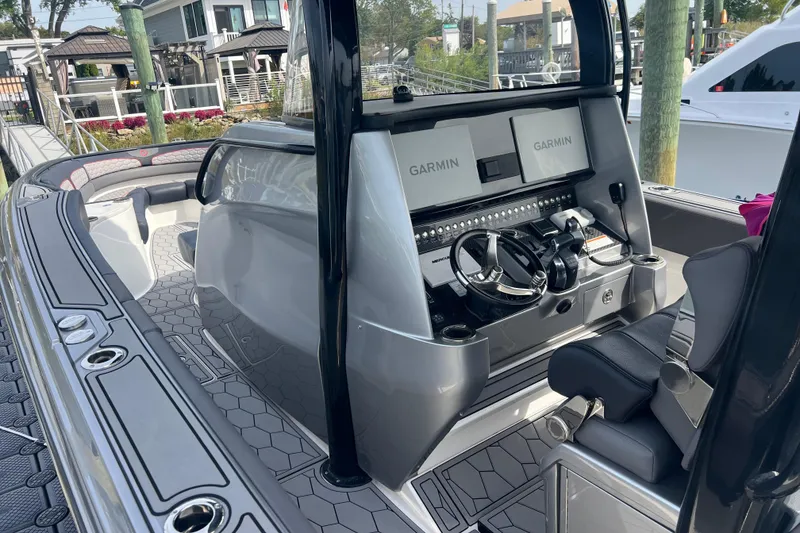 Slide: The Image of 2021 Fountain 39 NX boat cockpit with Garmin navigation, sleek design, and comfortable seating. - 12