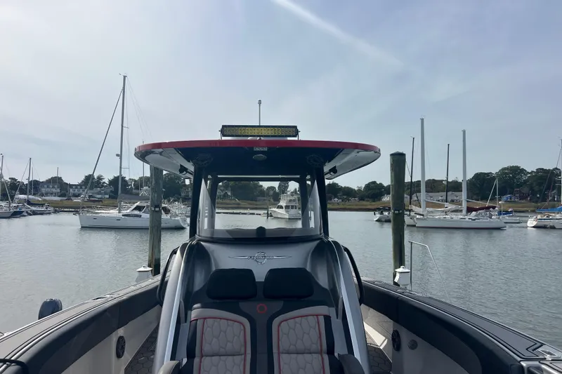 Slide: The Image of 2021 Fountain 39 NX boat docked in a marina with sailboats in the background. - 18
