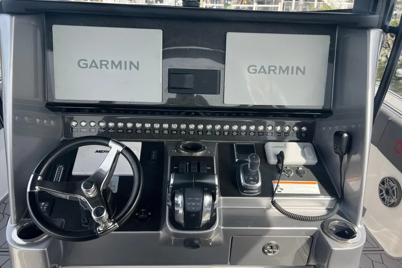 Slide: The Image of 2021 Fountain 39 NX boat dashboard with Garmin displays and steering wheel. - 19