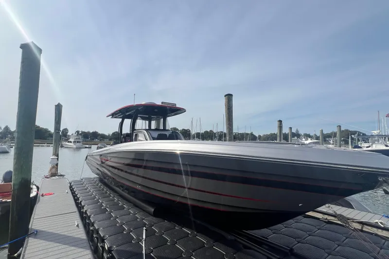 The Image of 2021 Fountain 39 NX boat docked at a marina under a clear sky. - 2