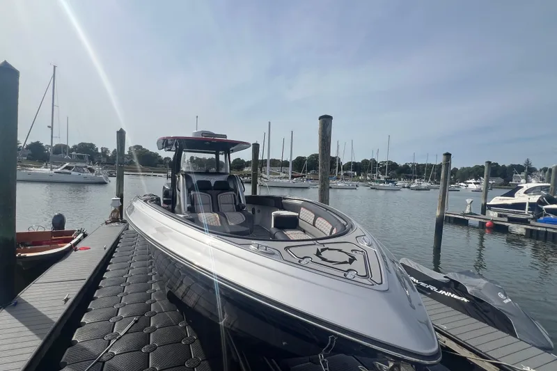 Slide: The Image of 2021 Fountain 39 NX boat docked at marina with sailboats in background. - 4
