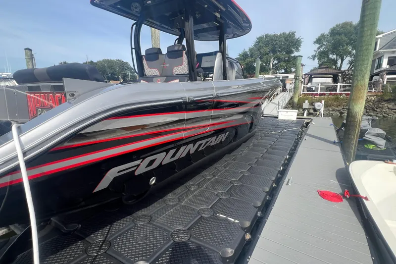 Slide: The Image of 2021 Fountain 39 NX boat docked, showcasing sleek design and modern features. - 3