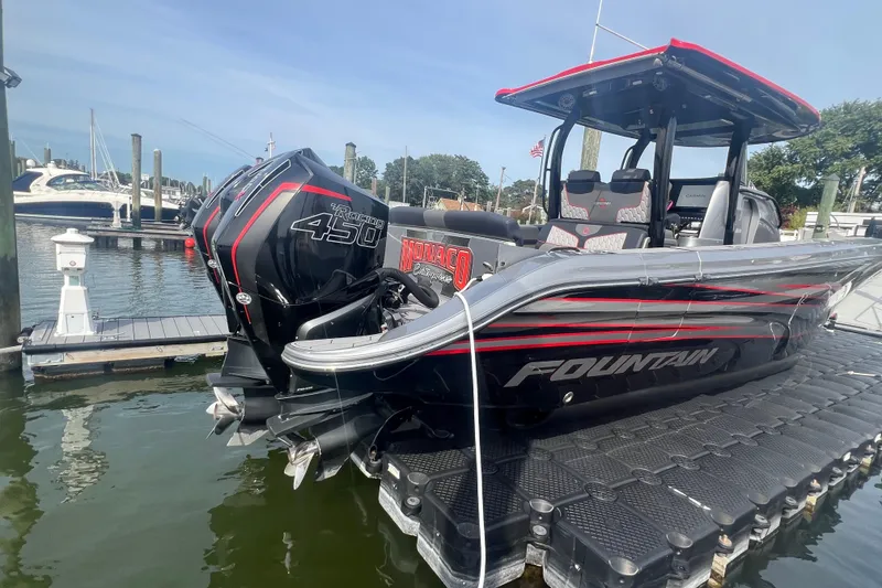 Slide: The Image of 2021 Fountain 39 NX boat docked, featuring powerful Mercury Racing 450 engines. - 7
