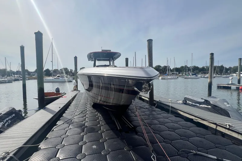 Slide: The Image of 2021 Fountain 39 NX boat docked at marina with clear sky background. - 5