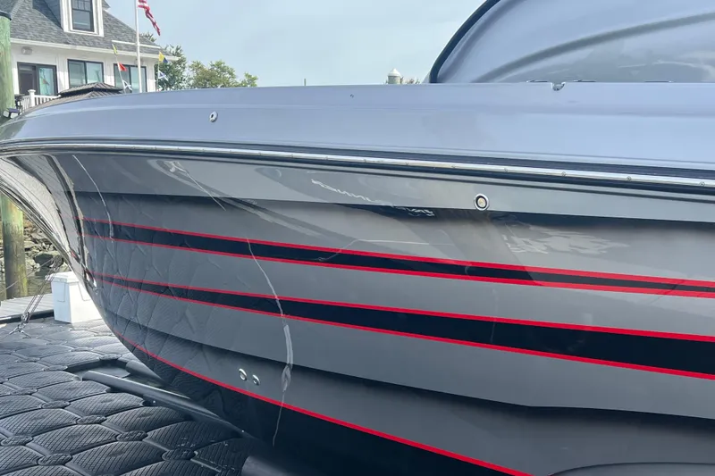 Slide: The Image of 2021 Fountain 39 NX boat with sleek gray and red-striped hull design. - 8