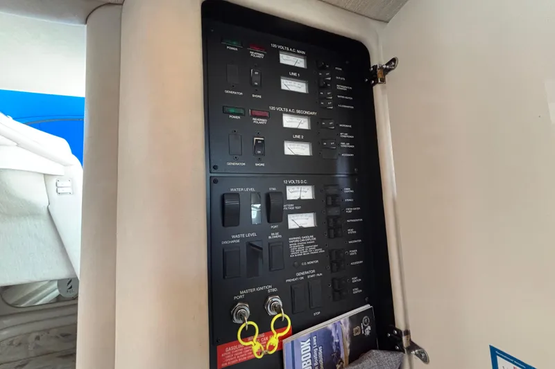 Slide: The Image of Control panel inside a 1995 Sea Ray 330 Sundancer boat, featuring various switches and gauges. - 17