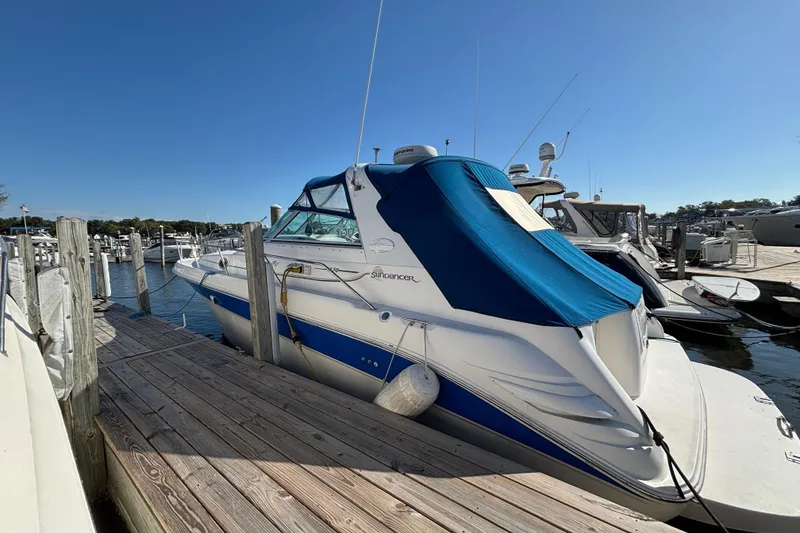 Slide: The Image of 1995 Sea Ray 330 Sundancer docked at marina under clear blue sky. - 3