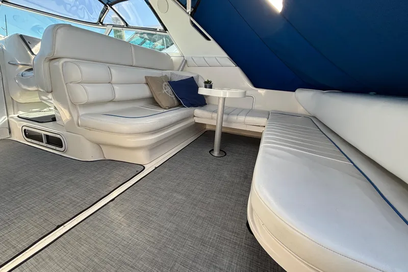 Slide: The Image of Interior of 1995 Sea Ray 330 Sundancer with white seating and blue accents. - 4