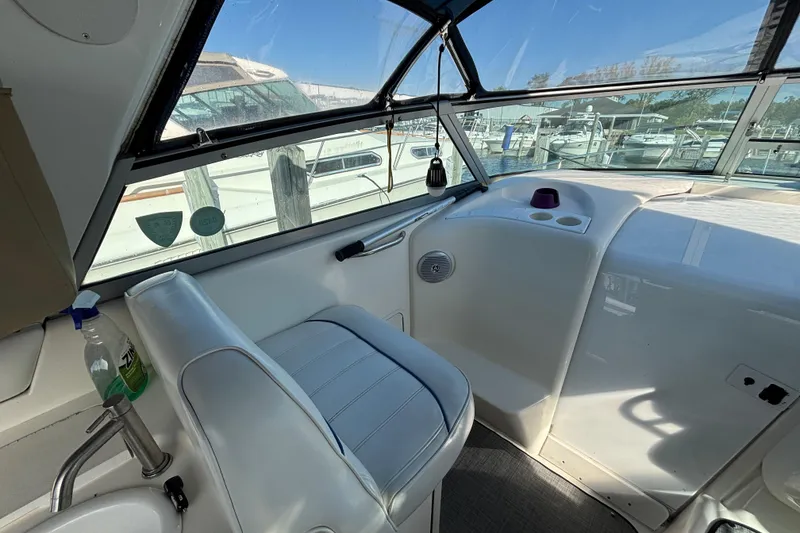 Slide: The Image of Interior of a 1995 Sea Ray 330 Sundancer boat, featuring helm seating and dashboard. - 6
