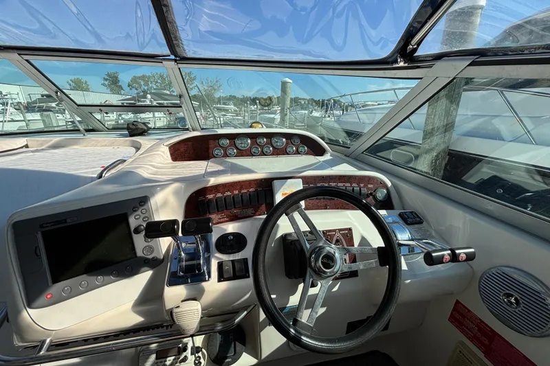 Slide: The Image of Cockpit view of a 1995 Sea Ray 330 Sundancer with steering wheel and control panel. - 8