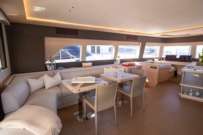 Slide: The Image of Luxurious interior of 2021 Lagoon Seventy 7 yacht with modern seating and large windows. - 10