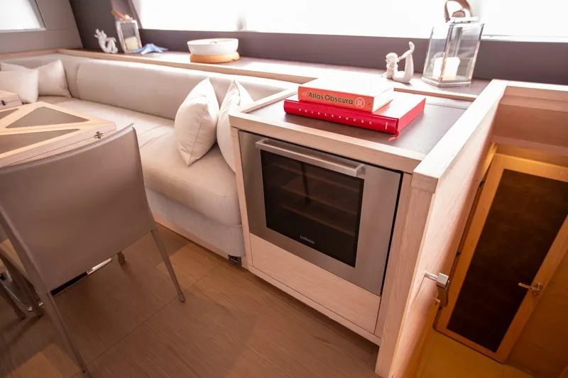 Slide: The Image of Luxurious interior of 2021 Lagoon Seventy 7 yacht with modern seating and built-in oven. - 14