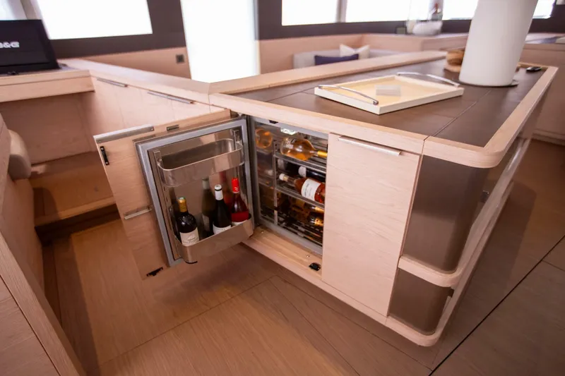 Slide: The Image of Luxury yacht Lagoon Seventy 7 interior with open wine fridge, showcasing modern design. - 15