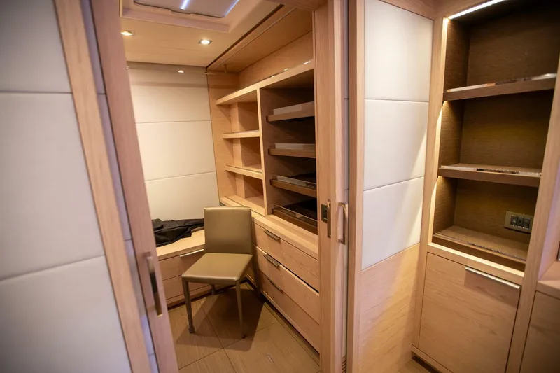 Slide: The Image of Luxurious wooden interior of 2021 Lagoon Seventy 7 yacht with shelves and chair. - 24
