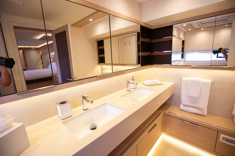 Slide: The Image of Luxurious bathroom in a 2021 Lagoon Seventy 7 yacht with dual sinks and modern design. - 26