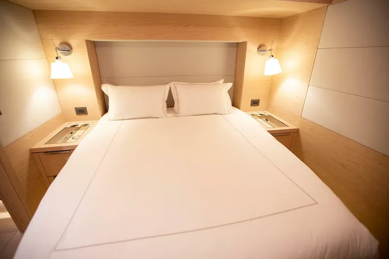 Slide: The Image of Luxurious bedroom interior of 2021 Lagoon Seventy 7 yacht with cozy lighting and modern design. - 30