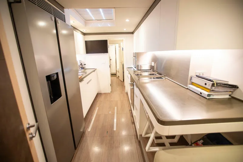 Slide: The Image of Luxurious 2021 Lagoon Seventy 7 yacht kitchen with modern appliances and sleek design. - 32