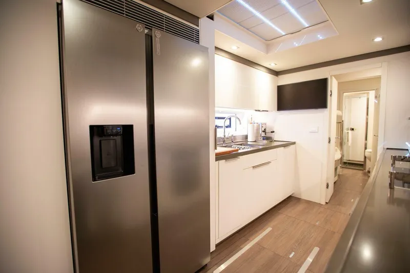 Slide: The Image of Modern kitchen interior on 2021 Lagoon Seventy 7 yacht, featuring stainless steel appliances. - 33