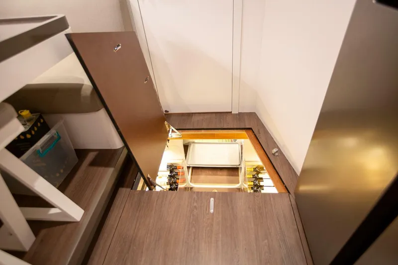 Slide: The Image of Interior of 2021 Lagoon Seventy 7 yacht with open floor storage compartment. - 35