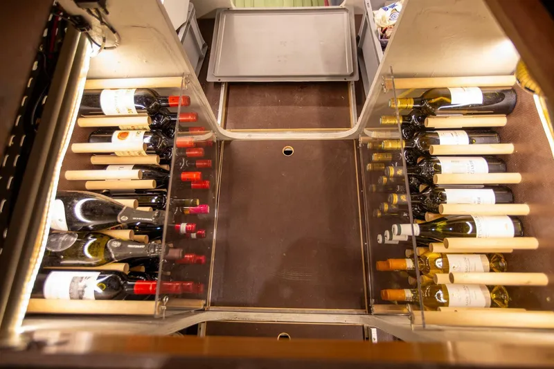 Slide: The Image of Wine storage area in a 2021 Lagoon Seventy 7 yacht, featuring organized wine bottles. - 36