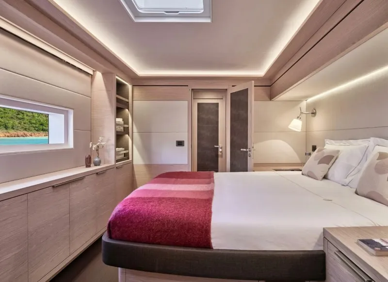 Slide: The Image of Luxurious bedroom interior of 2021 Lagoon Seventy 7 yacht with modern design and cozy ambiance. - 7