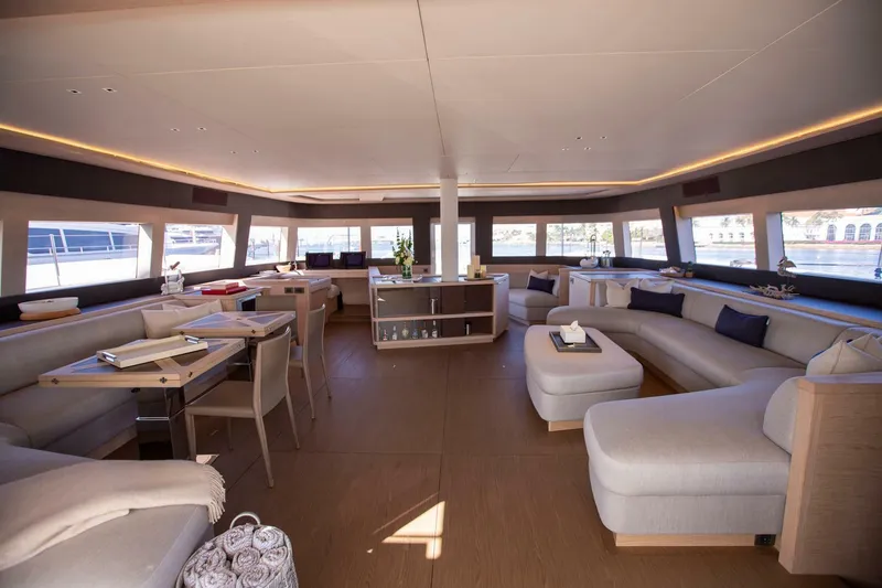 Slide: The Image of Luxurious interior of 2021 Lagoon Seventy 7 yacht with elegant seating and panoramic windows. - 8