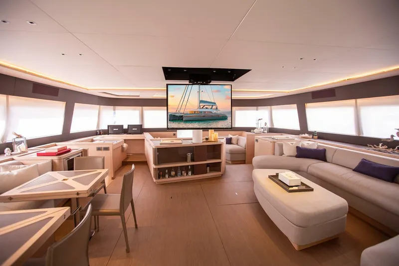 Slide: The Image of Luxurious interior of 2021 Lagoon Seventy 7 yacht with modern furnishings and large windows. - 9