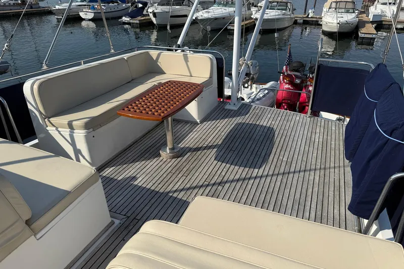 Slide: The Image of Deck of 1996 Grand Banks 42 Classic yacht with covered equipment and seating. - 12