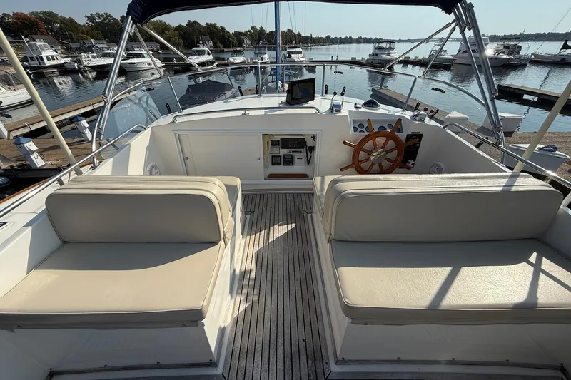 Slide: The Image of Grand Banks 42 Classic yacht, 1996 model, docked with scooters on deck. - 13