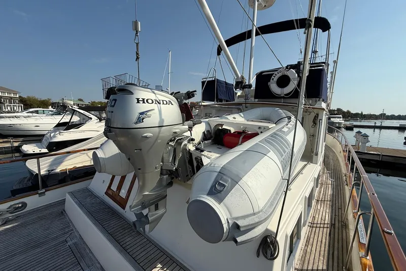 Slide: The Image of 1996 Grand Banks 42 Classic yacht deck with seating and table, docked at marina. - 16