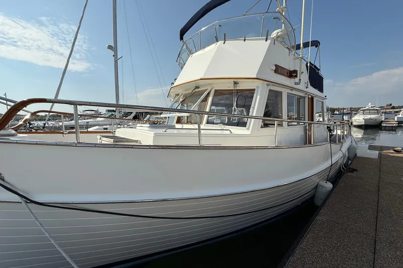 Slide: The Image of Cozy bedroom interior of a 1996 Grand Banks 42 Classic yacht with wooden furnishings. - 2