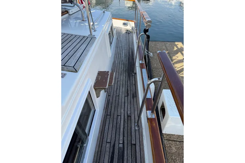 Slide: The Image of 1996 Grand Banks 42 Classic yacht with motorcycles and dinghy on deck. - 21