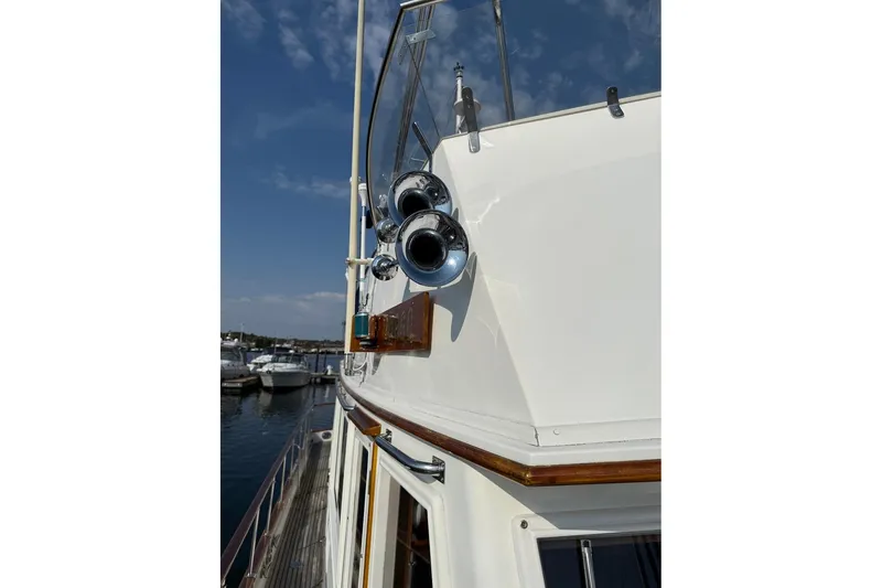 Slide: The Image of Motorbike secured on 1996 Grand Banks 42 Classic yacht deck with green straps. - 22