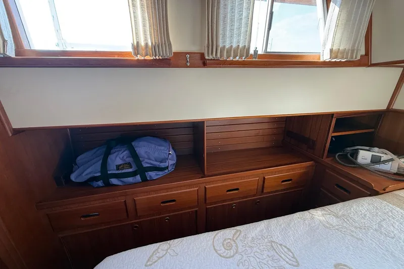 Slide: The Image of Cozy bedroom interior of 1996 Grand Banks 42 Classic yacht with wooden furnishings. - 36