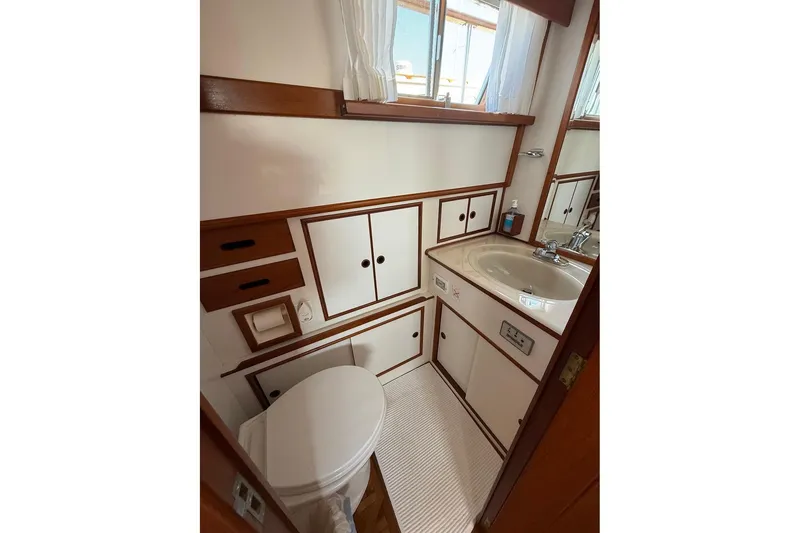 Slide: The Image of Interior of 1996 Grand Banks 42 Classic yacht with wooden cabinetry and storage. - 38
