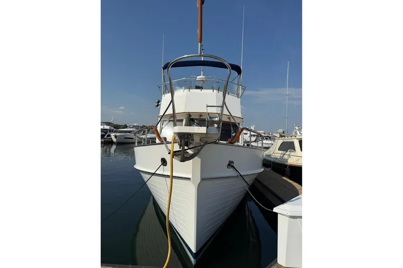 Slide: The Image of Interior of 1996 Grand Banks 42 Classic yacht with wood paneling and cushioned seating. - 4