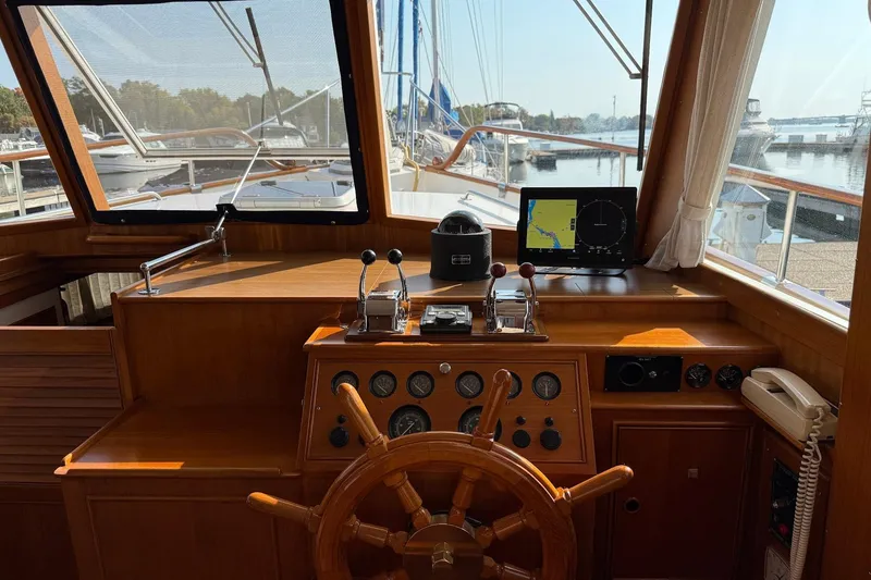 Slide: The Image of Interior view of 1996 Grand Banks 42 Classic yacht helm with wooden steering wheel. - 49