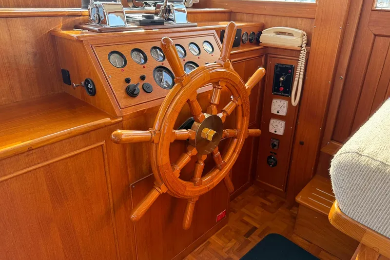 Slide: The Image of Helm of 1996 Grand Banks 42 Classic yacht with wooden wheel and navigation equipment. - 50