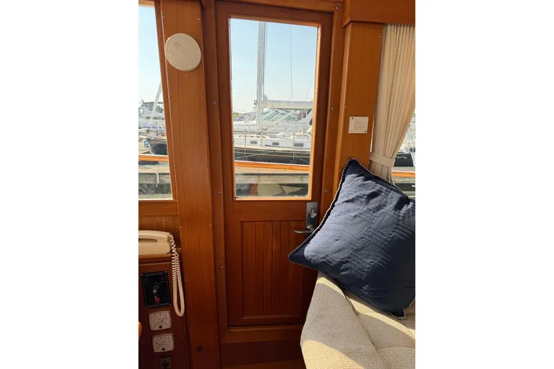 Slide: The Image of Wooden helm of a 1996 Grand Banks 42 Classic yacht with gauges and controls. - 51