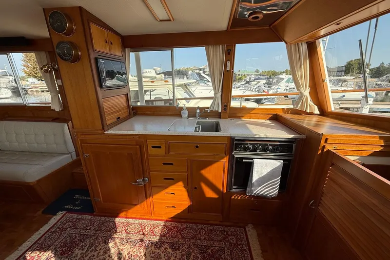 Slide: The Image of Interior of 1996 Grand Banks 42 Classic yacht with wooden door and blue cushion. - 52