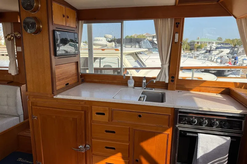 Slide: The Image of Interior of 1996 Grand Banks 42 Classic yacht with wooden cabinetry and marina view. - 53