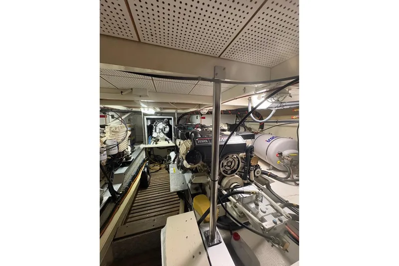 Slide: The Image of Engine room of a 1996 Grand Banks 42 Classic yacht, showcasing mechanical components. - 61
