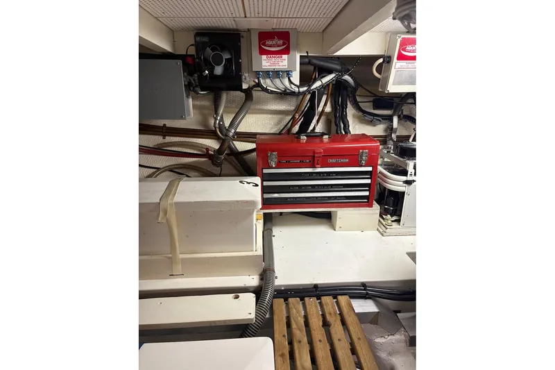 Slide: The Image of Engine room of 1996 Grand Banks 42 Classic with red toolbox and wiring. - 63