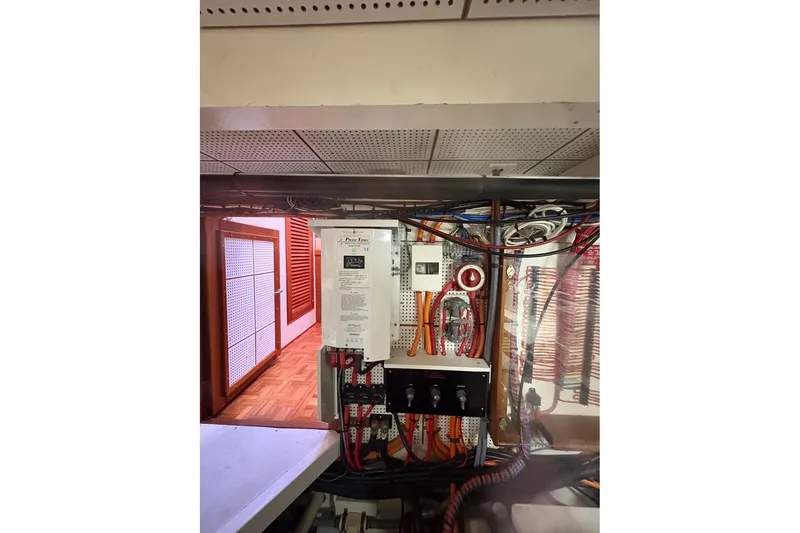 Slide: The Image of Electrical panel inside 1996 Grand Banks 42 Classic yacht, showcasing wiring and controls. - 66