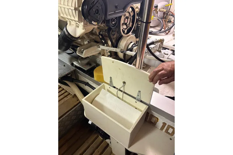 Slide: The Image of Engine compartment of 1996 Grand Banks 42 Classic with maintenance tools and paper towel holder. - 67