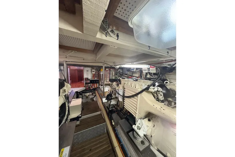 Slide: The Image of Engine room of a 1996 Grand Banks 42 Classic yacht, showcasing mechanical components. - 72
